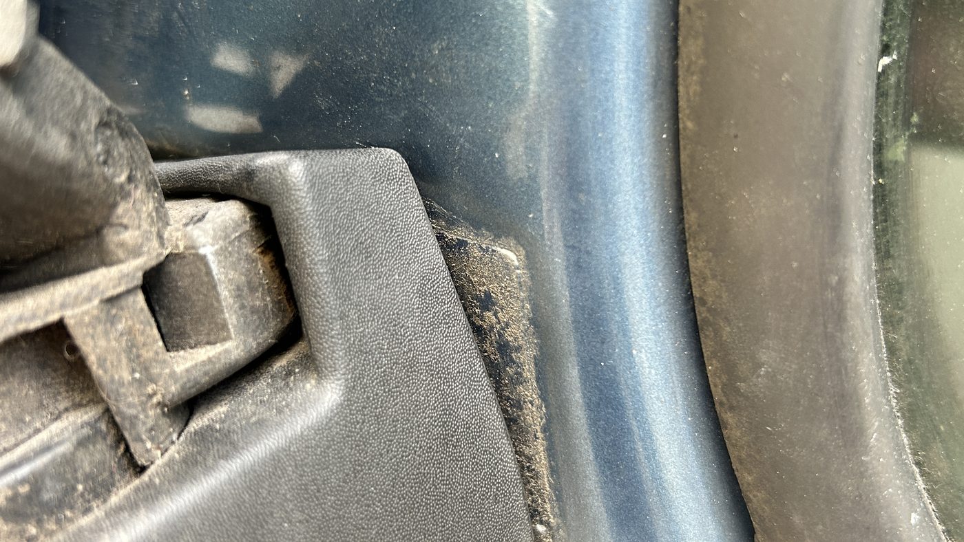 Schadenbereich an einem Fahrzeug aus der Nähe, die Beschädigung setzt sich hinter der Außenhaut fort